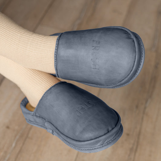 Deep Baltic leather clogs worn indoors, anatomical shoes for comfort. Soft leather slippers Deep Baltic, eco-friendly anatomical footwear lifestyle photo.