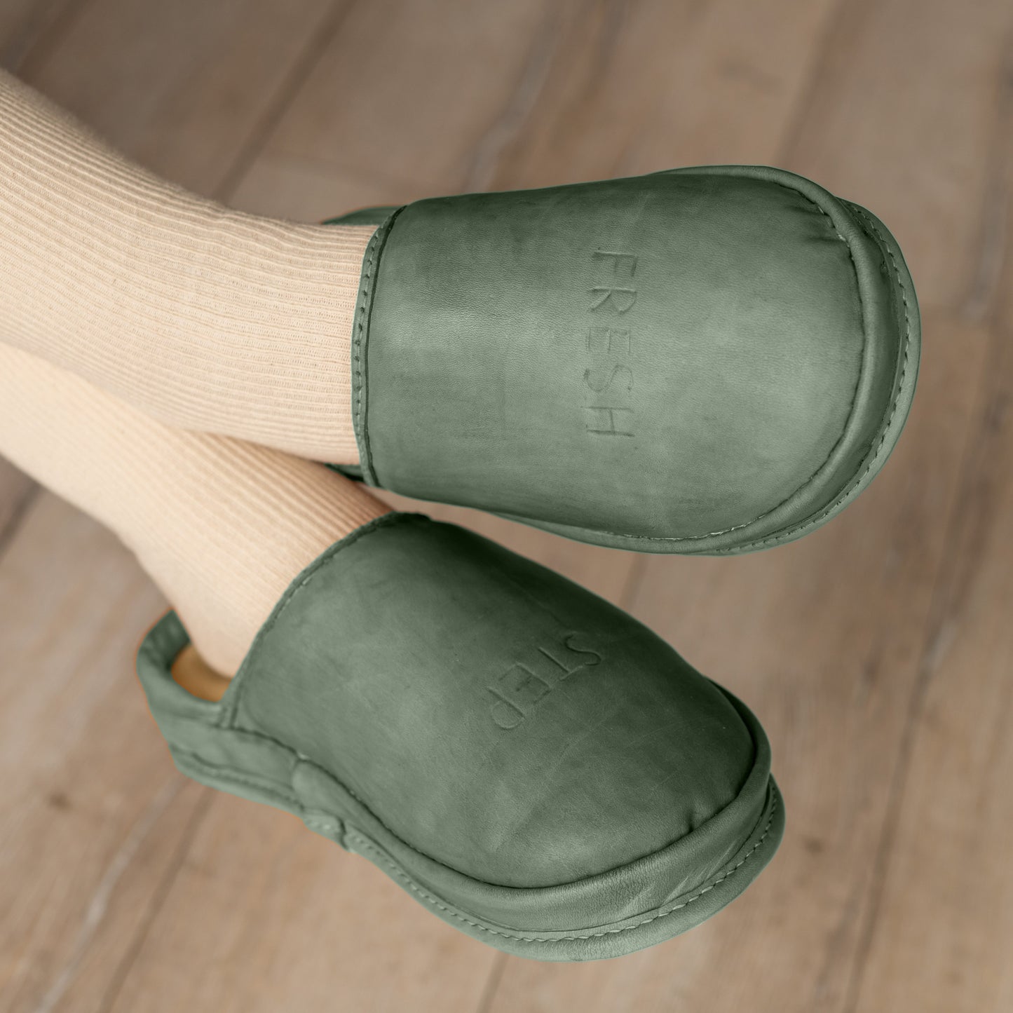 Anatomical shoes in Moss Whisper tone worn indoors. A perfect pair of natural leather clogs for everyday wear.