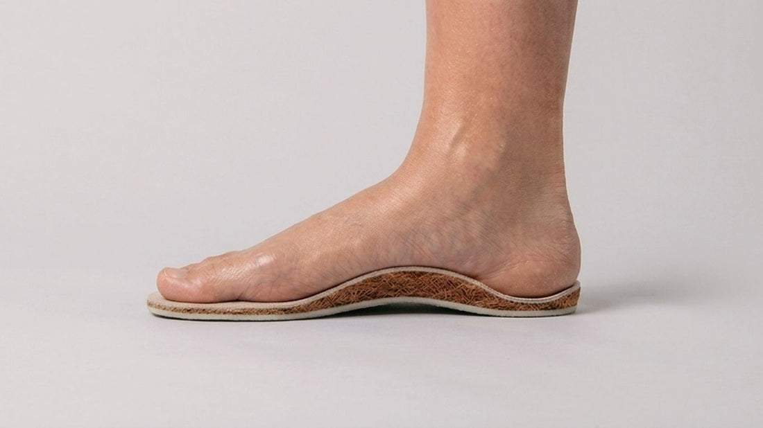 Bare foot resting on a SPA GAIT adaptive leather insole with visible coconut fibre arch support. Cover image for the article Arch Support Insoles: How Adaptive Support Shapes to Your Foot.