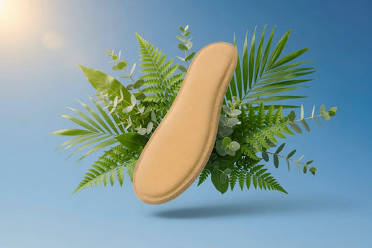 SPA·GAIT premium leather insole surrounded by fresh tropical green leaves and plants on a blue background