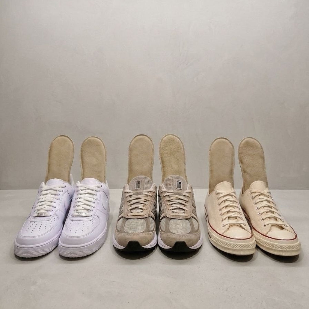 SPA·GAIT adaptive leather insoles placed inside three different sneakers: Nike Air Force 1, New Balance and Converse