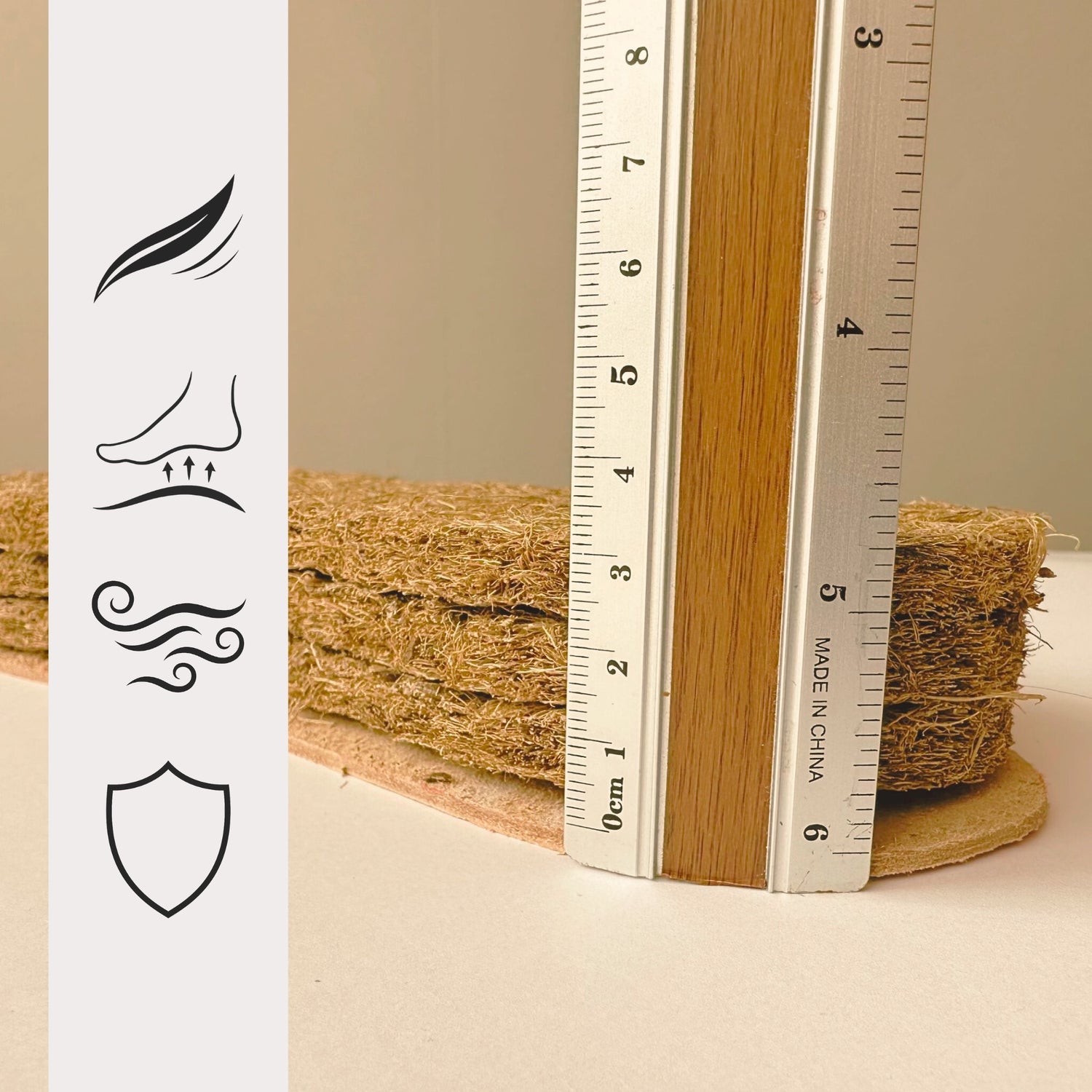 Close-up of SPA GAIT's innovative coconut fiber footbed next to a ruler, demonstrating the material's thickness. This core provides exceptional clogs comfort and anatomical shoes support.

Detail shot of the layered, eco friendly coconut fiber footbed, the key component in SPA GAIT's natural clogs. Icons highlight the material's breathability, lightness, and durability.
