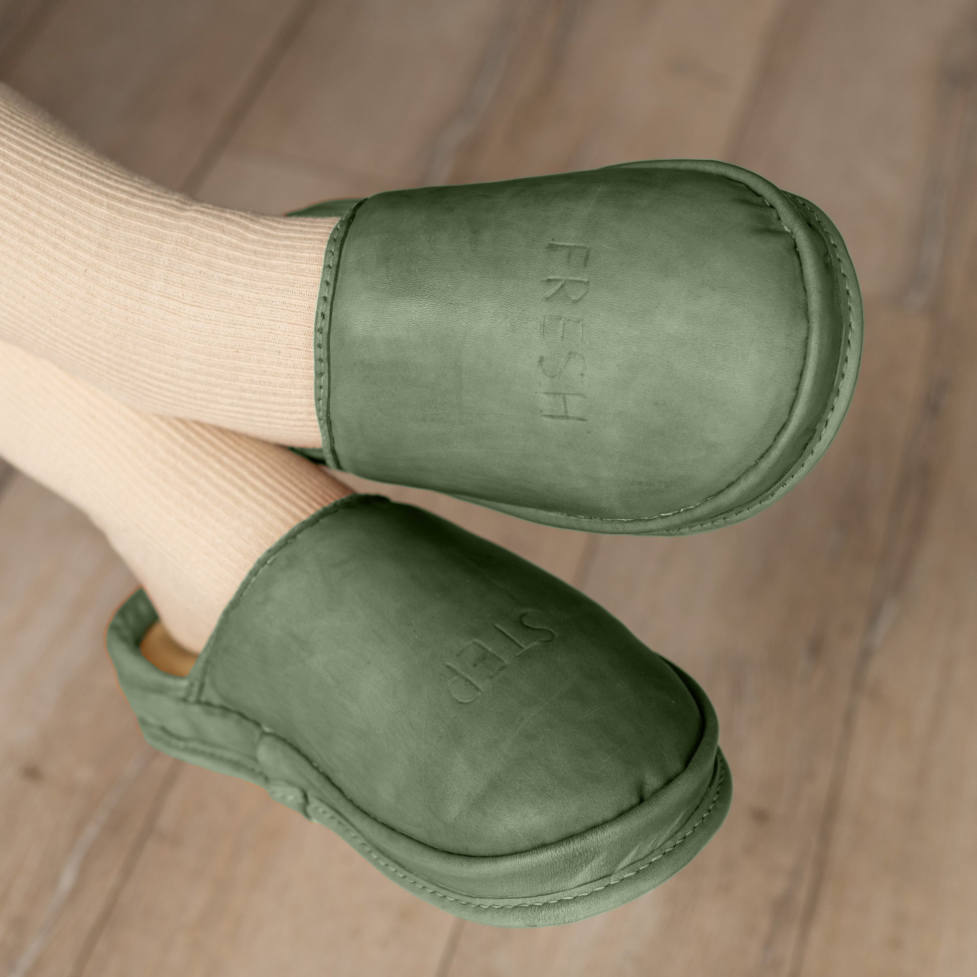 A person wearing Forest Core soft leather clogs. These natural leather shoes provide anatomic comfort and a relaxed fit.