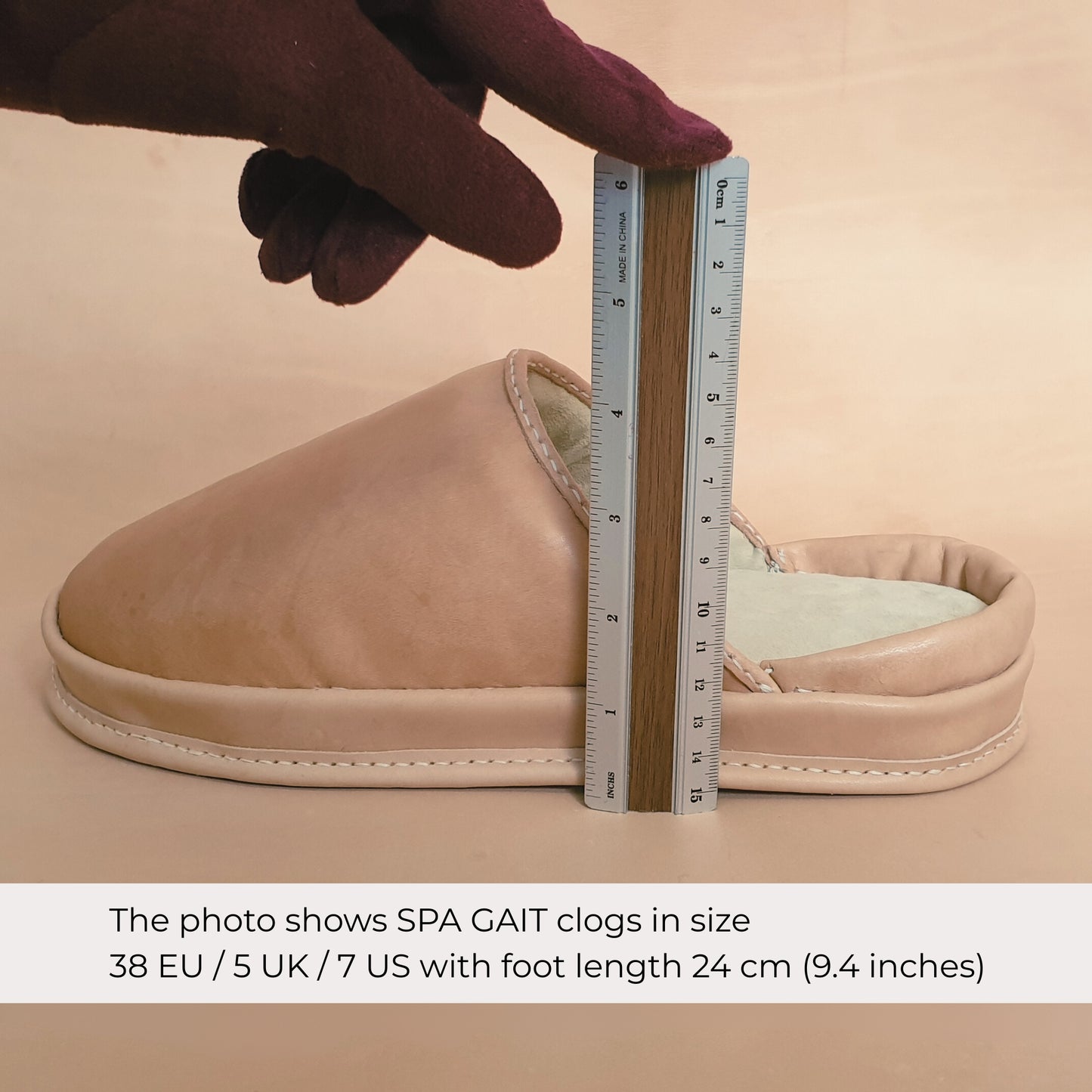 Beige clog with a ruler showing size 38 EU/5 UK/7 US and foot length 24 cm on a beige background.