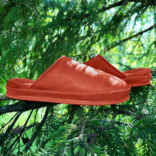 Comfortable anatomical Terracotta Ember clogs forest backdrop. Nature-inspired Terracotta Ember eco-friendly leather clogs. 