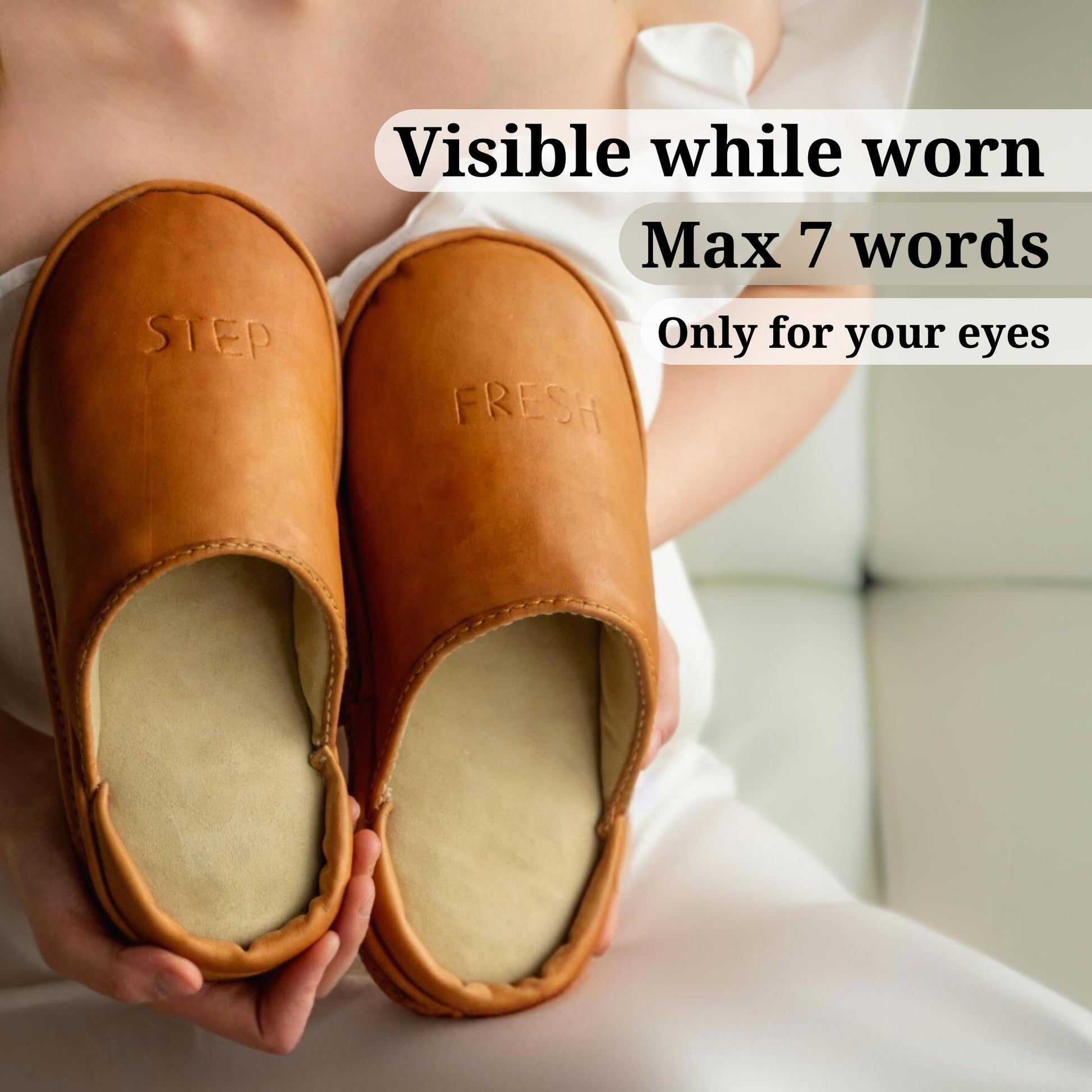 SPA GAIT Mocha Skin adaptive clogs held in hands. Natural leather indoor footwear with anatomical footbed and minimalist design. Embossed words “STEP” and “FRESH” visible while worn — a personal message for the wearer only. Made from durable vegetable-tanned leather that moulds to the foot over time. Plastic-free, breathable, handcrafted adaptive clogs for all-season home comfort.
