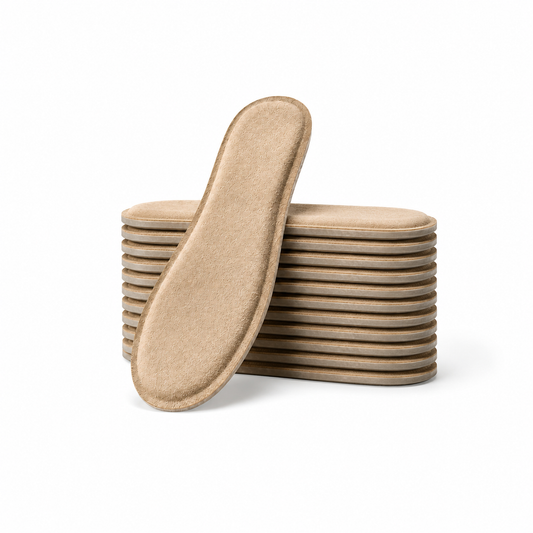SPA GAIT Basic Adaptive Leather Insoles 10 Pairs stacked with one insole leaning against the pile, showing the light beige genuine leather surface and slim adaptive design.