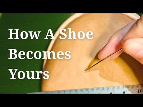 Video still from SPA GAIT showing the personalisation process of brown leather clogs. A hand works on natural leather, applying custom text and botanical dye. Highlights the handcrafted transformation from classic anatomical shoes to personalised eco friendly clogs. Sustainable materials, slow fashion values and adaptive comfort in every step.